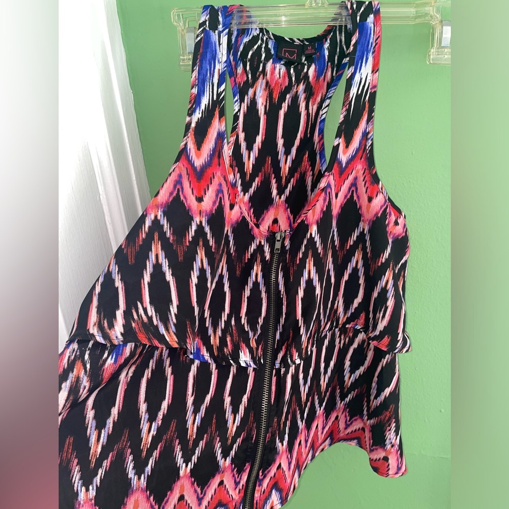 Never worn. Racerback zip front top.